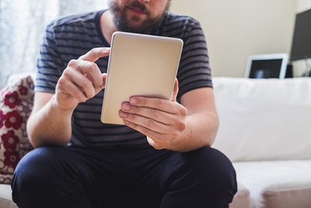 man reading a publication on the electrical industry