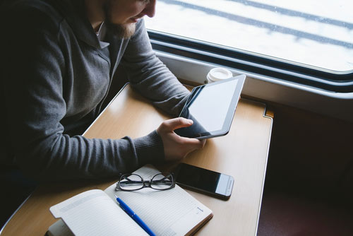 Man reading a blog to evaluate industry best practices